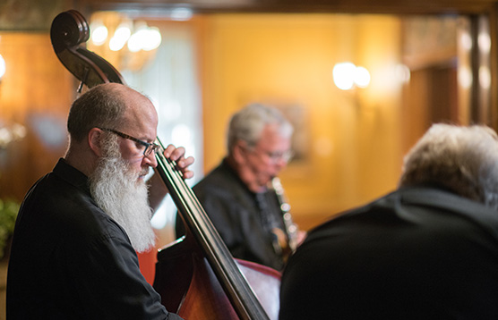 A group of people sitting around each other holding instruments.